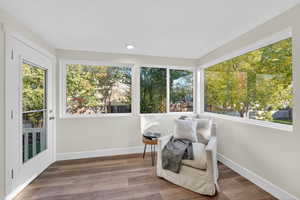 Sunroom / solarium with wood finished floors, plenty of natural light, and recessed lighting