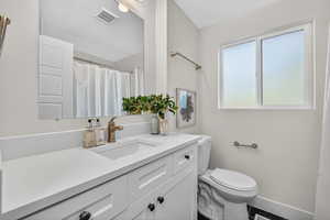 Full bath with vanity and curtained shower