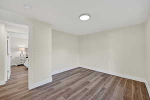Spare room with baseboards and light wood-type flooring