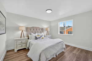 Bedroom with baseboards and wood finished floors