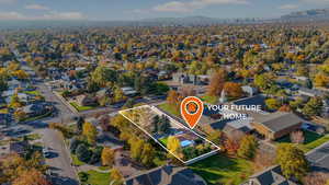 Aerial view of residential area featuring property parcel outlined and a mountainous background