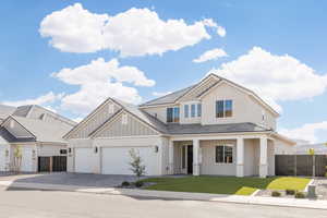 View of front of house featuring decorative driveway, covered porch, an attached garage, board and batten siding, and stucco siding