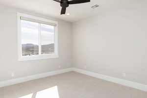 Unfurnished room featuring a mountain view, carpet flooring, recessed lighting, and ceiling fan