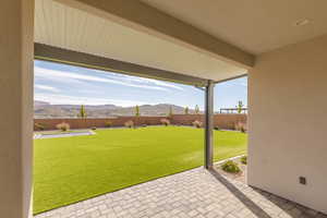 Fenced backyard with a mountain view and a patio