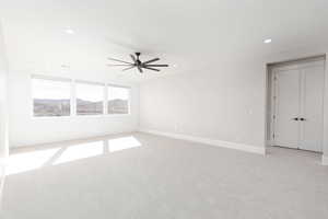 Spare room with light carpet, a mountain view, recessed lighting, and a ceiling fan