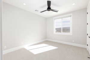 Unfurnished room with light colored carpet, recessed lighting, and a ceiling fan