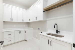 Laundry area featuring cabinet space, washer hookup, gas dryer hookup, electric dryer hookup, and light flooring