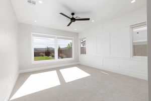 Empty room featuring carpet floors, a ceiling fan, and recessed lighting