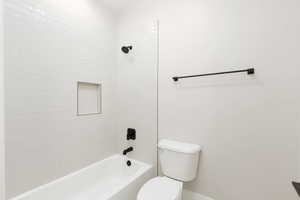 Bathroom featuring bathing tub / shower combination and toilet