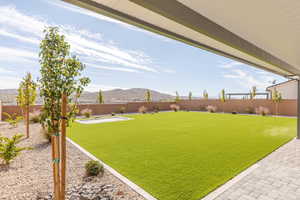 Fenced backyard with a patio area and a mountain view