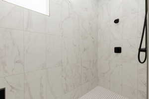 Full bath featuring a tile shower