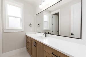 Bathroom with vanity and light tile patterned floors