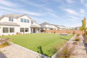 View of front of house featuring stucco siding, a fenced backyard, and a residential view