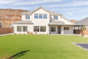 Back of property with a fenced backyard, stucco siding, a patio area, and a mountain view