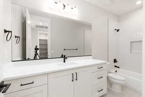 Full bathroom with vanity,  shower combination, light tile patterned flooring, recessed lighting, and a spacious closet