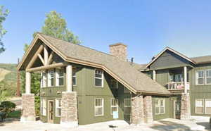 Craftsman inspired home with a balcony, a chimney, and board and batten siding