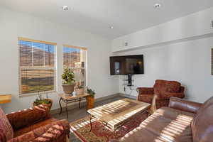 Living area with wood finished floors and recessed lighting