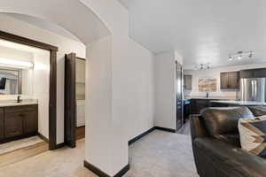 Living area featuring light colored carpet and washer / dryer