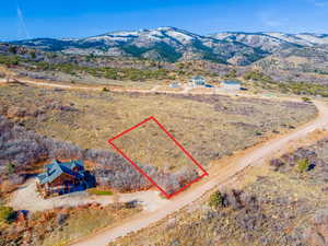 View from above of property with property parcel outlined and mountains
