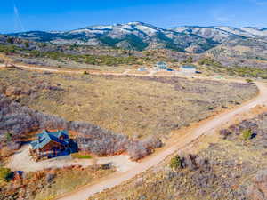Aerial view of property and surrounding area with mountains