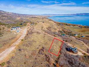 Aerial overview of property's location featuring property boundaries highlighted and a water and mountain view