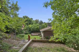 View of yard featuring view of wooded area