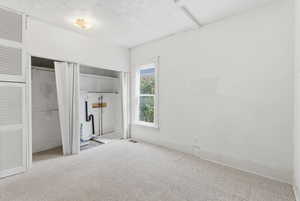 Unfurnished bedroom with carpet flooring and baseboards