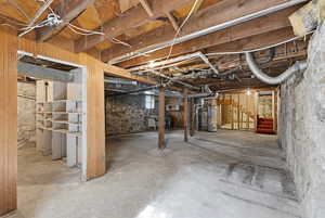 Basement featuring stairway and water heater