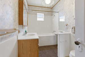 Bathroom with vanity, wallpapered walls, shower / washtub combination, and ornamental molding
