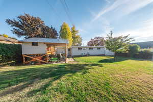 Rear view of property with a metal roof and a patio