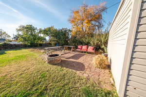 View of yard with a patio area and a fire pit