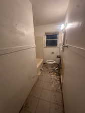 Bathroom with tile patterned flooring and  shower combination