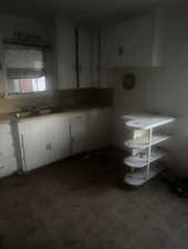 Kitchen with white cabinets and light countertops