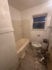 Bathroom featuring light tile patterned flooring and bathing tub / shower combination