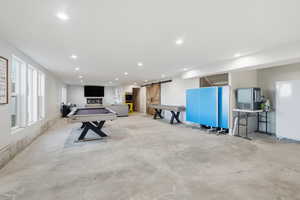 Playroom with a barn door, concrete floors, billiards, and recessed lighting