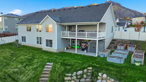 Rear view of house featuring a patio area, a fenced backyard, a wooden deck, a shingled roof, and stairway