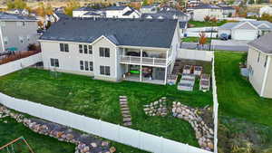 Rear view of property featuring a patio area, a shingled roof, a residential view, stairs, and a fenced backyard