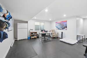 Gym/Office with recessed lighting and dark flooring