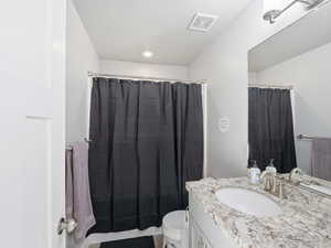Bathroom featuring vanity and curtained shower