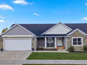 Craftsman-style home with stone siding, a porch, a shingled roof, concrete driveway, and an attached garage