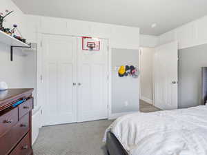 Bedroom with a closet and light colored carpet