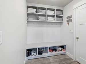 Mudroom featuring baseboards and wood finished floors