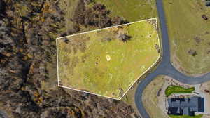 Aerial view of property and surrounding area with property parcel outlined