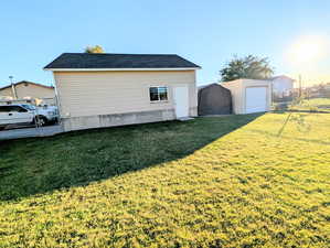 View of side of home featuring an outbuilding