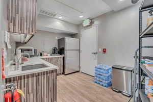 Kitchen in within the office.  There is more space in the common area that could be used for client gatherings.