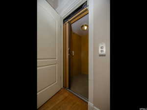 Hall featuring light wood finished floors and elevator