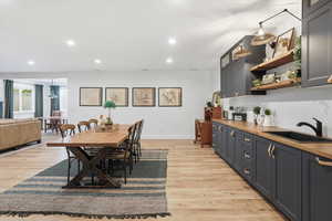 Dining space with recessed lighting and light wood-style flooring