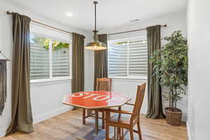 Dining room with light wood-style flooring and baseboards