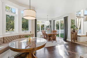 Dining space with healthy amount of natural light and hardwood / wood-style floors
