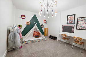 Game room with carpet and baseboards